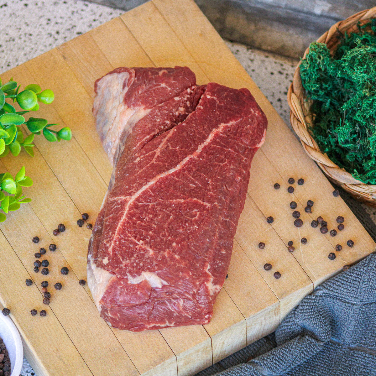 Raw grass-fed English roast on a wooden board with peppercorns – Waseda Farms